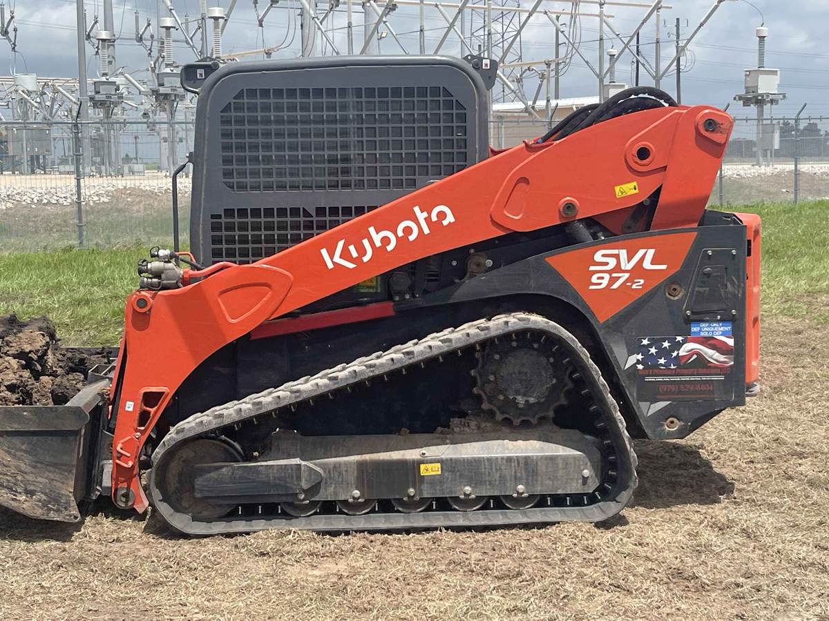 Ron's Premium Property Solutions Kubota SVL97 track loader working outside a substation